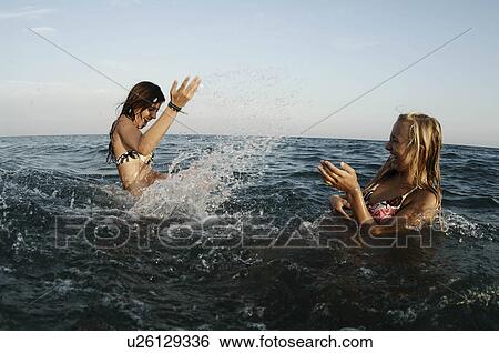 Girls teenagers playing in the sea View Large Photo Image Stock Photograph - Girls teenagers playing in the sea. Fotosearch