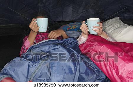 Girls with hot drink in tent View Large Photo Image Stock Image - Girls with hot drink in tent. Fotosearch