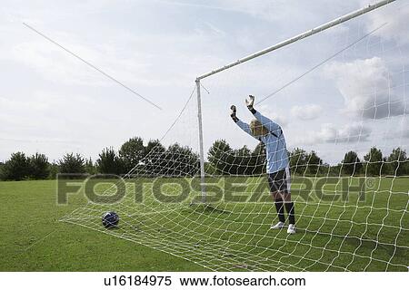 Goalkeeper standing next to net View Large Photo Image Stock Photography - Goalkeeper standing next to net. Fotosearch