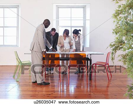 Stock Photo - Group of businesspeople in meeting. Fotosearch