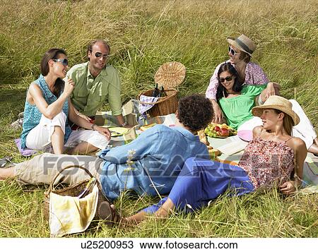 Group of friends having a picnic View Large Photo Image Stock Image - Group of friends having a picnic. Fotosearch