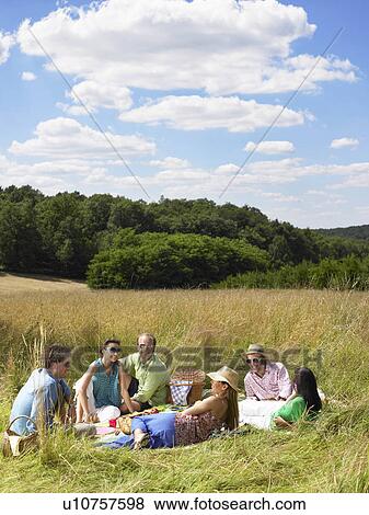 Stock Photo - Group of friends having a picnic. Fotosearch