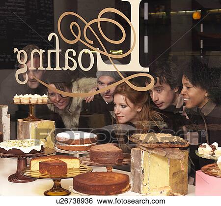 Group of friends looking through window View Large Photo Image Stock Photograph - Group of friends looking through window. Fotosearch