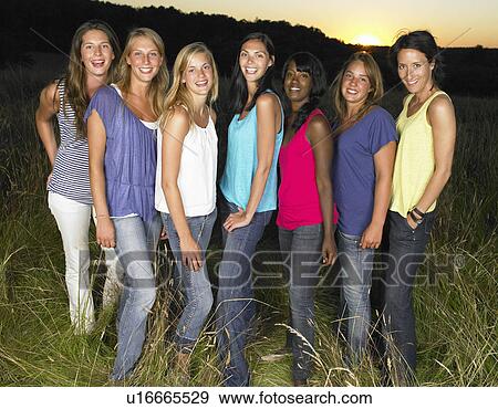 "Group of girlfriends in a field, smiling" View Large Photo Image Stock Photo - "Group of girlfriends in a field, smiling". Fotosearch