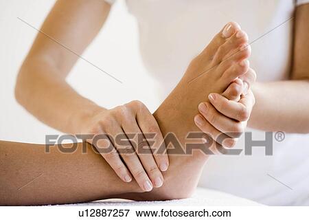 Stock Photo - Hand massaging feet. Fotosearch