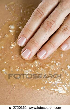 Stock Image - Hand massaging skin. Fotosearch