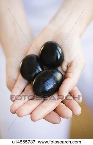 Hands holding hot stones View Large Photo Image Stock Photo - Hands holding hot stones. Fotosearch