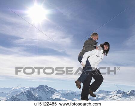 Stock Photography - Hikers playing piggyback ride. Fotosearch
