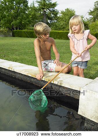 Stock Image - Kids fishing in a pond. Fotosearch