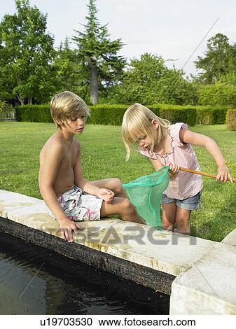 Kids fishing in a pond View Large Photo Image Stock Image - Kids fishing in a pond. Fotosearch