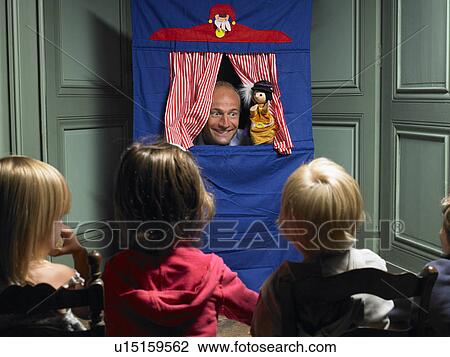Stock Image - Kids watching a puppet show. Fotosearch