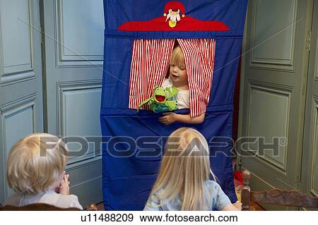 Kids watching a puppet show View Large Photo Image Stock Photo - Kids watching a puppet show. Fotosearch