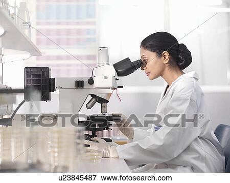 Stock Photo - Laboratory technician and microscope. Fotosearch