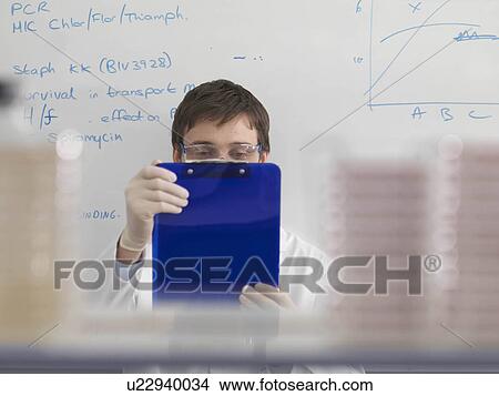 Picture - Laboratory technician with clipboard. Fotosearch