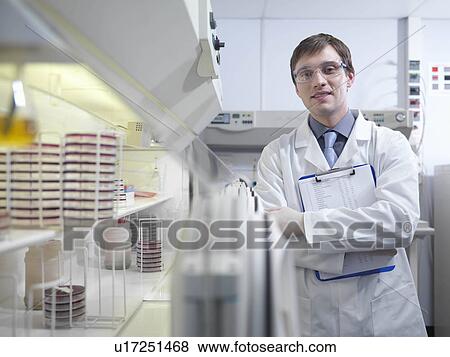 Stock Photo - Laboratory technician with clipboard. Fotosearch