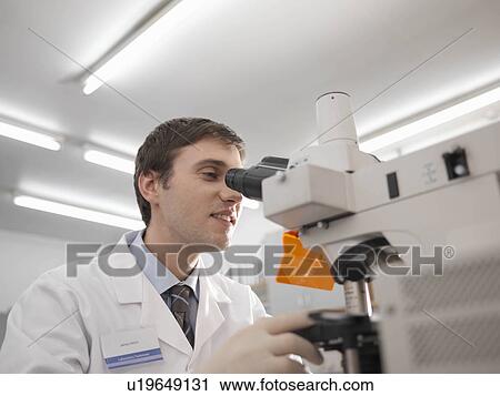 Laboratory technician with microscope View Large Photo Image Stock Image - Laboratory technician with microscope. Fotosearch