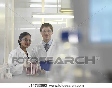 Stock Image - Laboratory technicians and petri dishes. Fotosearch