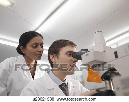 Laboratory technicians at microscope View Large Photo Image Stock Photo - Laboratory technicians at microscope. Fotosearch