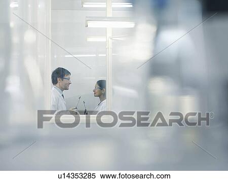 Stock Photography - Laboratory technicians in window. Fotosearch
