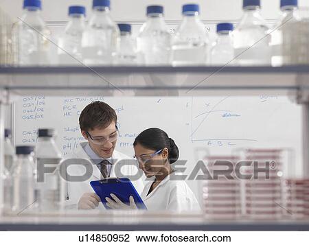 Stock Image - Laboratory technicians with clipboard. Fotosearch