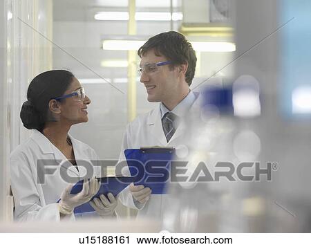 Stock Image - Laboratory technicians with clipboards. Fotosearch