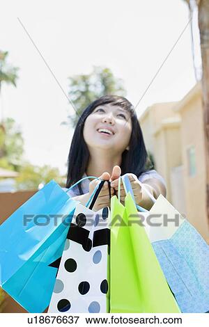 Stock Photo - Laughing teen with shopping bags. Fotosearch