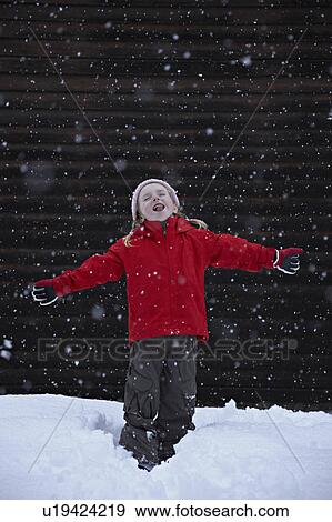 Stock Photo - Little girl catching snowflakes. Fotosearch