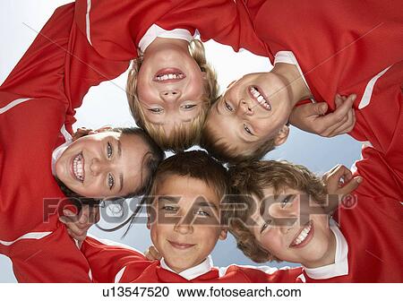 Low viewpoint of young football team View Large Photo Image Stock Image - Low viewpoint of young football team. Fotosearch