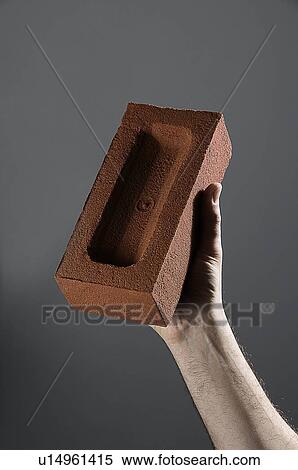 Male hand holding a brick View Large Photo Image Stock Photography - Male hand holding a brick. Fotosearch