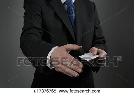 Stock Photography - Male holding business card. Fotosearch
