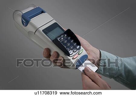 Male holding credit card machine View Large Photo Image Stock Photo - Male holding credit card machine. Fotosearch