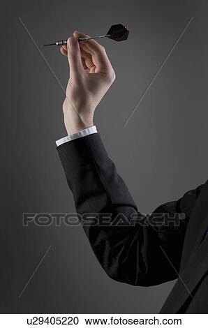 Male holding dart View Large Photo Image Stock Image - Male holding dart. Fotosearch