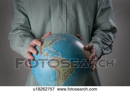 Stock Photo - Male holding globe. Fotosearch