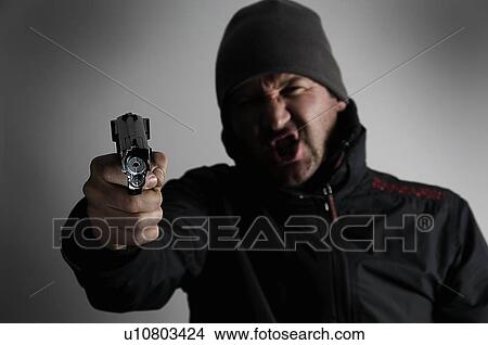Male holding gun View Large Photo Image Picture - Male holding gun. Fotosearch