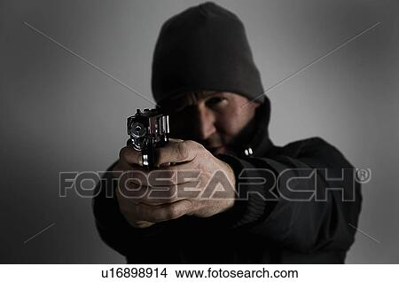 Picture - Male holding gun. Fotosearch