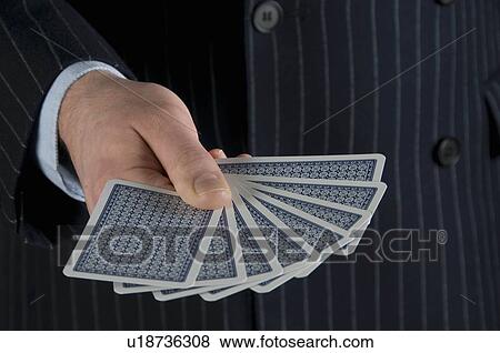 Stock Photo - Male holding playing cards. Fotosearch