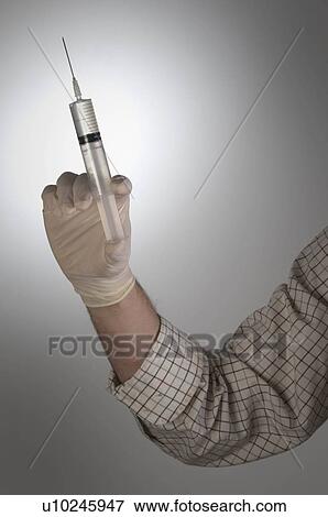 Stock Photo - Male holding syringe. Fotosearch