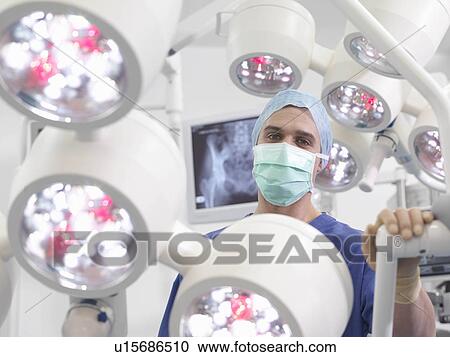 Stock Image - Male nurse in operating theatre. Fotosearch