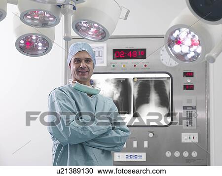 Male surgeon with x-rays in theatre View Large Photo Image Stock Image - Male surgeon with x-rays in theatre. Fotosearch