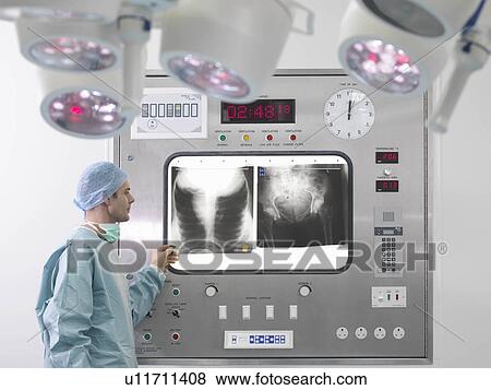 Stock Photo - Male surgeon with x-rays. Fotosearch