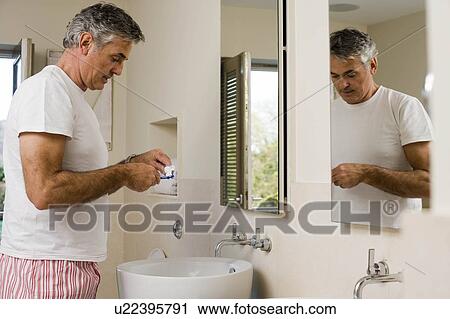 Stock Image - Man about to brush teeth. Fotosearch