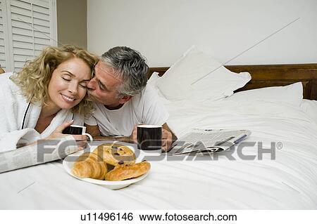 Stock Photograph - Man and woman having breakfast. Fotosearch