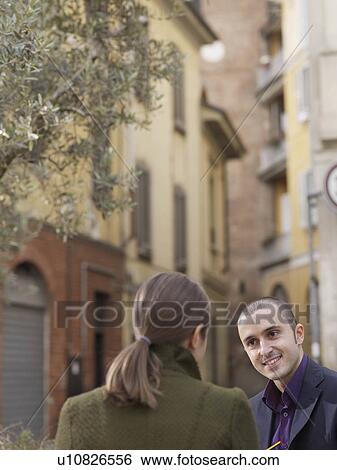 Stock Photograph - Man and woman in European street. Fotosearch