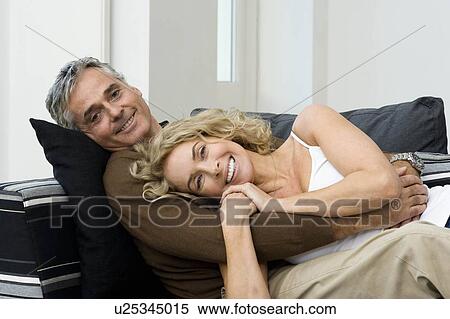 Stock Photography - Man and woman on sofa. Fotosearch