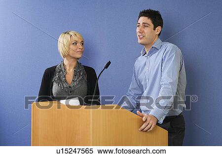 Man and woman speaking from lectern View Large Photo Image Stock Photography - Man and woman speaking from lectern. Fotosearch