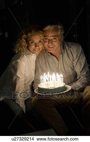 Picture - Man and woman with cake. Fotosearch