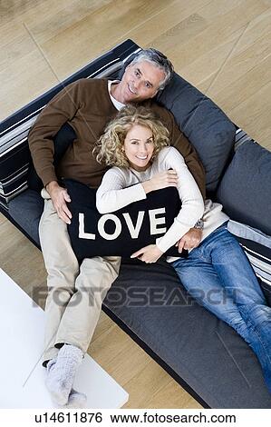 Stock Photograph - Man and woman with cushion. Fotosearch