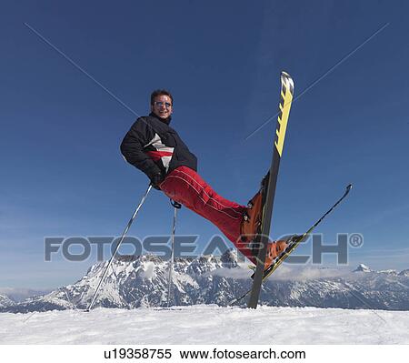 Man balancing on skis and skiing poles View Large Photo Image Stock Photography - Man balancing on skis and skiing poles. Fotosearch