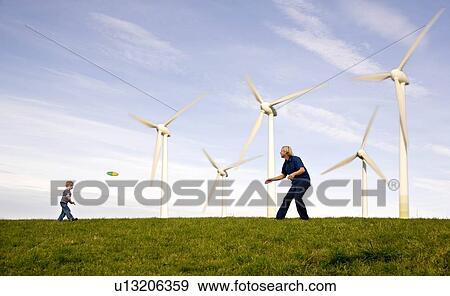 "Man, boy play Frisbee at Wind Turbines" View Large Photo Image Stock Photo - "Man, boy play Frisbee at Wind Turbines". Fotosearch