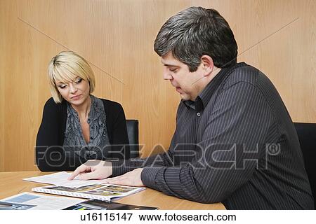 Man discussing work with colleague View Large Photo Image Stock Photo - Man discussing work with colleague. Fotosearch